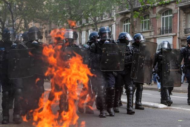 May 1, 2024, France: Police move in as several street fires are lit. Violent clashes erupt as thousands of protesters and trade unions gather in Paris for this year s International Workers Day.?Originally a day to celebrate labourers and the working class, this year sees a continuation of protests against president Macron™s leadership.?Heavy clashes erupted as anti-capitalists joined the march, engaging in street battles with riot police; hurling bricks, bottles and smashing shop windows. Police responded with tear gas and baton charges. France - ZUMAs197 20240501_aaa_s197_335 Copyright: xChristopherxWallsx