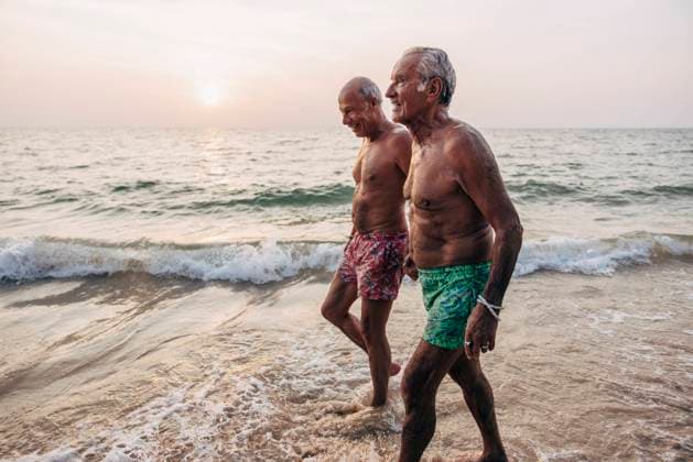Creative Highlights Symbolbilder Senior shirtless gay couple holding hands while walking near shore at beach against sky Thailand, Ko Lanta, model released Copyright: xMaskotx , MA109367 MA109367