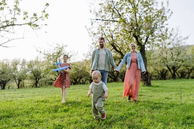 Family portrait with daughter and small toddler, baby, walking outdoors in spring nature. Family portrait with daughter and small toddler or baby, walking outdoors in spring nature. Nuclear family. model released