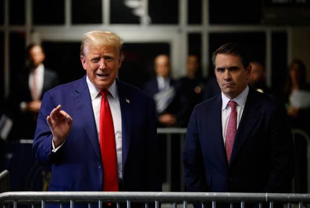 President Donald Trump speaks to reporters (L) while accompanied by his lead attorney Todd Blanche as he leaves his trial at Manhattan criminal court in New York on Monday, May 6, 2024. Trump s criminal trial is entering its fourth week on charges he allegedly falsified business records to cover up a sex scandal during the 2016 presidential campaign. Pool photo by Peter Foley  NYP20240506755 PeterxFoley