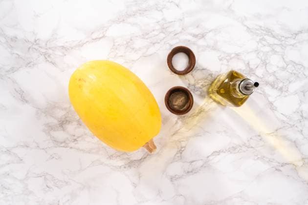 Spaghetti squash Preparing organic spaghetti squash with olive oil, salt, and pepper. Copyright: xArinaxHabich RECORD DATE NOT STATED