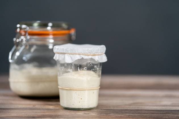 Sourdough starter Feeding sourdough starter in a glass mason jar for baking artisan bread. Copyright: xArinaxHabich RECORD DATE NOT STATED
