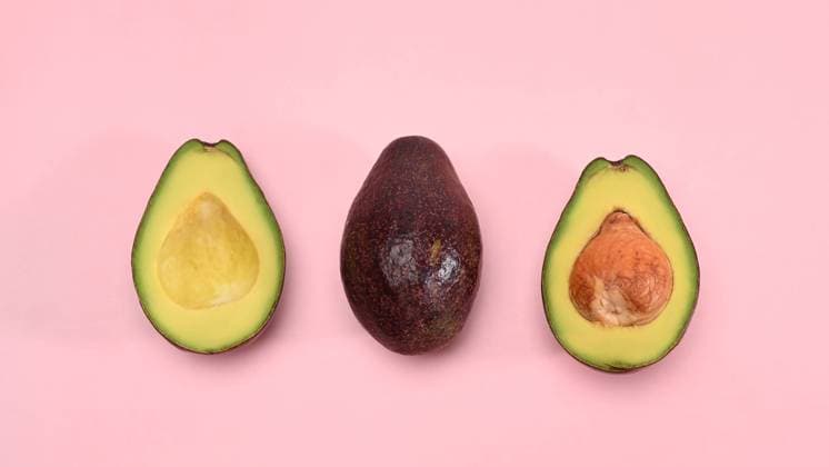 Whole and half avocado isolated on pink background. Whole and half avocado isolated on pink background. Copyright: x RECORD DATE NOT STATED