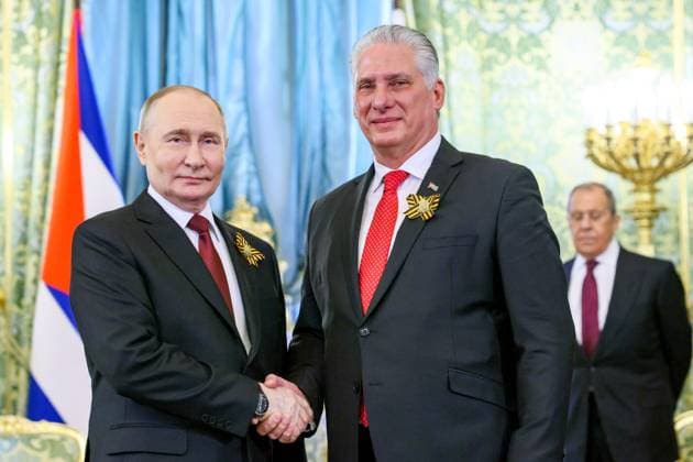 RUSSIA, MOSCOW - MAY 9, 2024: Russia s President Vladimir Putin (L) and his Cuban counterpart Miguel Diaz-Canel shake hands during a meeting at the Moscow Kremlin. Mikhail Metzel Russian Presidential Press and Information Office TASS  69835963
