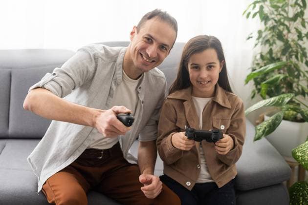excited father and daughter playing video game at home. excited father and daughter playing video game at home Copyright: xsinenkiy RECORD DATE NOT STATED