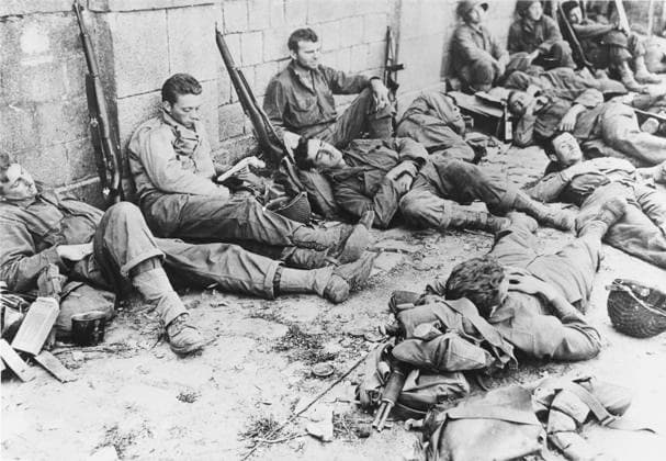 RECORD DATE NOT STATED D-Day - US Troops resting following initial assault US troops rest after the initial assault on the Normandy coast. D-Day began on June 6th, 1944 at 6:30am and was conducted in two assault phases  Copyright: Copyrightx(c)Geminix2023.xCredit:xGemini 10282383