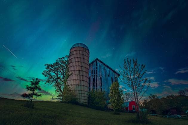 May 10, 2024, Monroe, Wisconsin, USA: A farm at night as a meteor jets through the sky during aurora borealis, also known as the northern lights, towers over rural Wisconsin. Monroe USA - ZUMAh190 20240510_shv_h190_555 Copyright: xRossxHarriedx