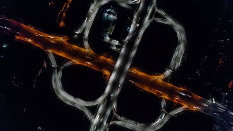 Aerial drone top view at roundabout lane, traffic on junction of night city Aerial drone top view at roundabout lane, traffic on junction of night city. Cars and trucks driving on multi-level highway. Transportation, infrastructure development concept. Copyright: x RECORD DATE NOT STATED
