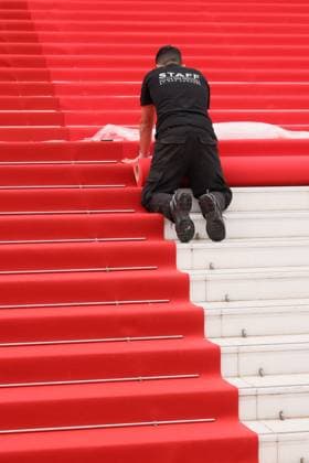 Cannes Red Carpet Roll Out DB Staff members work on the red carpet roll out ahead of the 77th annual Cannes Film Festival held at the palais des Festivals on May 14, 2024 in Cannes, France. Photo by David Boyer ABACAPRESS.COM  Copyright: xBoyerxDavid ABACAx
