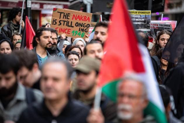People gather to stage a protest against Israeli attacks on Gaza and to commemorate 76th anniversary of Nakba Day in Istanbul A protester was seen carrying a banner reading THE NAKBA IS STILL ON GOING SINCE 1948 during the march. People gather to stage a protest against Israeli attacks on Gaza and to commemorate 76th anniversary of Nakba Day in Istanbul, Turkey. A commemorative protest was held at Eminonu to mark Nakba Day. Demonstrators gathered in front of the large post office (PTT) in Sirkeci and marched to Eminonu square. Istanbul Turkey Copyright: xOnurxDogmanx xSOPAxImagesx ODOGMAN_0040