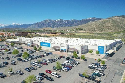 An aerial view of Walmart shopping center and retail store with the mountains of the Sierra Nevada behind it 24590187