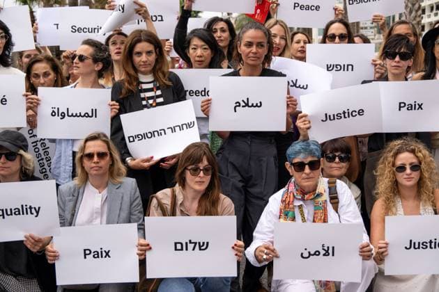 Cannes - Guerrieres De La Paix Flash Mob Action for Gaza and Israel French film director Valerie Donzelli (center) and other women from ?Women warriors of peace? carrying messages in French, Arabic, Hebrew and English stating ?Peace?, ?Cease Fire?, Release the Hostages?, demonstrate on the ?Croisette? in Cannes, to draw attention to the situation in Gaza and Israel, around the 77th Cannes Film Festival, in Cannes, France, on May 20, 2024. Photo by Ammar Abd Rabbo ABACAPRESS.COM Cannes France Copyright: xABACAx