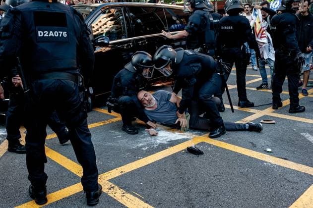 May 23, 2024, Barcelona, Spain: In the Park Guell neighborhood of Barcelona a man is detained by police officers during a protest against the Louis Vuitton fashion show. Barcelona residents gathered around Park GoÂ¼ell in Barcelona against the Louis Vuitton fashion show and protesting various social issues such as mass tourism, gentrification, animal rights or the commercialization and privatization of public spaces by the city council. Barcelona Spain - ZUMAb137 20240523_fap_b137_005 Copyright: xJordixBoixareux