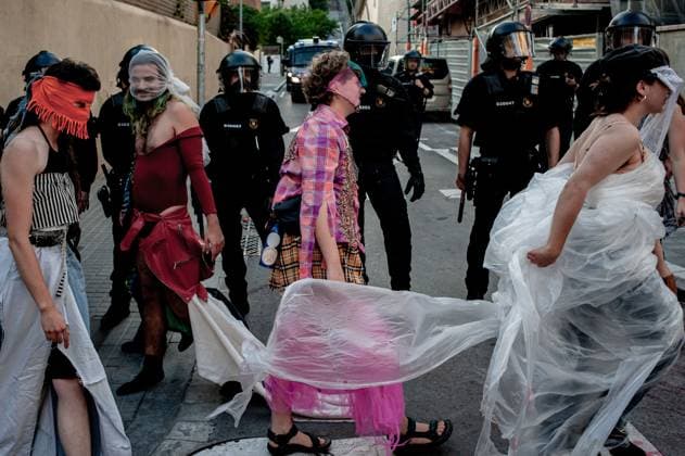 May 23, 2024, Barcelona, Spain: Protesters dressed as fashion models perform satirical way outside the Barcelona s Park Guell where Louis Vuitton fashion show was taking place. Barcelona residents gathered around Park GoÂ¼ell in Barcelona against the Louis Vuitton fashion show and protesting various social issues such as mass tourism, gentrification, animal rights or the commercialization and privatization of public spaces by the city council. Barcelona Spain - ZUMAb137 20240523_fap_b137_006 Copyright: xJordixBoixareux