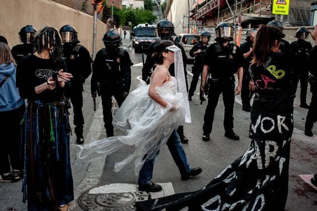 May 23, 2024, Barcelona, Spain: Protesters dressed as fashion models perform satirical way outside the Barcelona s Park Guell where Louis Vuitton fashion show was taking place. Barcelona residents gathered around Park GoÂ¼ell in Barcelona against the Louis Vuitton fashion show and protesting various social issues such as mass tourism, gentrification, animal rights or the commercialization and privatization of public spaces by the city council. Barcelona Spain - ZUMAb137 20240523_fap_b137_012 Copyright: xJordixBoixareux
