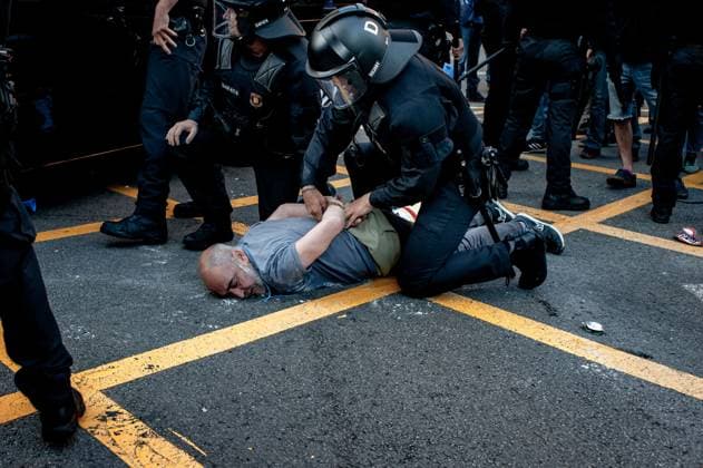 May 23, 2024, Barcelona, Spain: In the Park Guell neighborhood of Barcelona a man is detained by police officers during a protest against the Louis Vuitton fashion show. Barcelona residents gathered around Park GoÂ¼ell in Barcelona against the Louis Vuitton fashion show and protesting various social issues such as mass tourism, gentrification, animal rights or the commercialization and privatization of public spaces by the city council. Barcelona Spain - ZUMAb137 20240523_fap_b137_014 Copyright: xJordixBoixareux