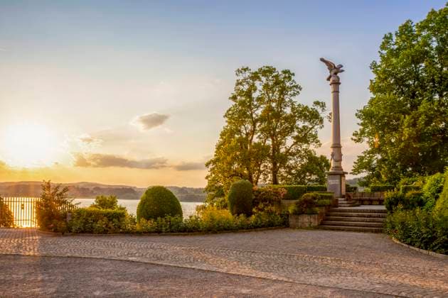 Statue on column amidst trees in park at Rapperswil, St Gallen Canton, Switzerland, MAMF03020