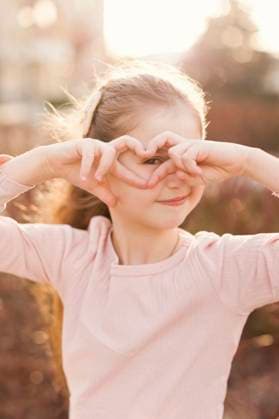 Creative Highlights Symbolbilder Smiling girl looking through heart shape gesture model released, Symbolfoto, ONAF00835