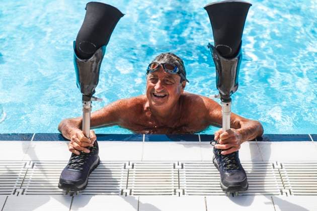 Creative Highlights Symbolbilder Happy shirtless senior man with prosthetic legs swimming in pool on sunny day model released, Symbolfoto property released, PCLF01166