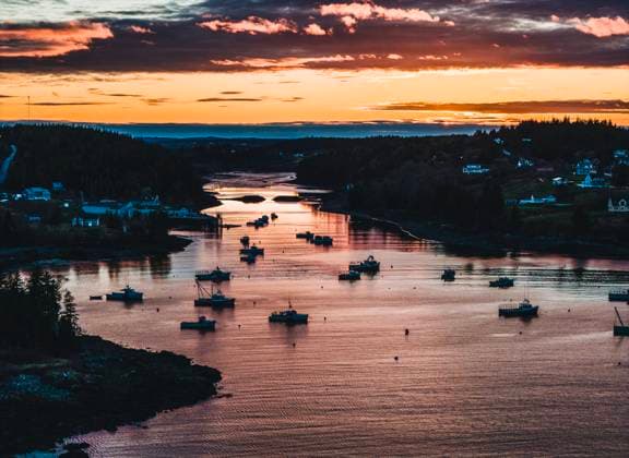 Vibrant sunset over lobster boats Cutler Harbor, downeast Maine Cutler, Maine, United States CR_SSNF240517-1437960-01