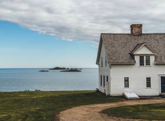 Old historic white house next to Atlantic Ocean, Machias, Maine Machias, Maine, United States R_SSNF240517-1437932-01