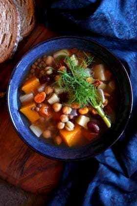 Sardinian-style minestrone longevity soup served with sourdough bread. Close up top down flatlay. Sardinian-style minestrone longevity soup served with sourdough bread. Close up top down flatlay. Copyright: xMilleflorexImagesx MIL290224-11