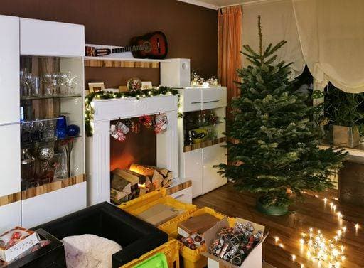 A real Nordmann fir tree is decorated for the Christmas tree. In the living room there are many boxes with jewelry. The light chain is on the floor. 24705630 ,property released RECORD DATE NOT STATED