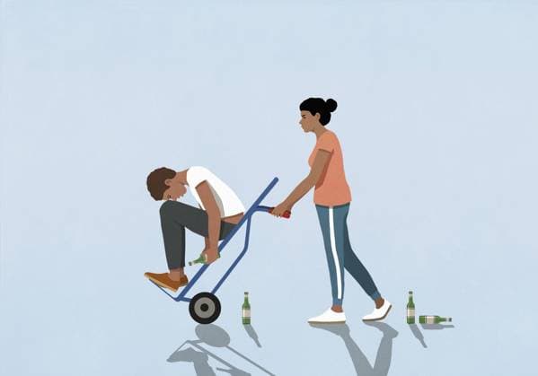 Wife pushing drunk husband on hand truck  Copyright: MaltexMueller fStopImages2073043