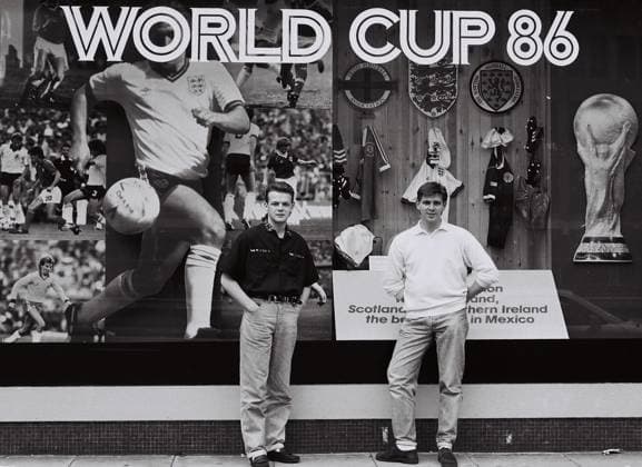 Two Friends stand in front of a display for the 1986 world cup at Thames TV hea Two Friends stand in front of a display for the 1986 world cup at Thames TV headquarters on the Euston Road.,  Copyright: xMarkxCharnockx xAvalonx 0531870590