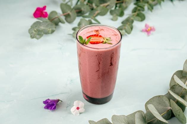 Glass of strawberry smoothie cocktail Glass of strawberry smoothie cocktail on the blue background Copyright: xZoonar.com MaximxSparishx 19849215