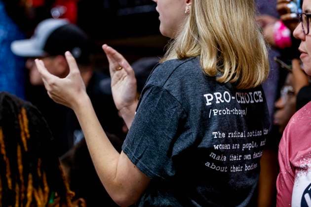 VP Harris Speaks on the One Year Anniversary of the US Supreme Court’s Dobbs Decision A woman wearing a pro-choice t-shirt listens to speakers before United States Vice President Kamala Harris speaks on the one year anniversary of the US Supreme Court’s Dobbs decision at the Grady Cole Center in Charlotte, North Carolina, USA, 24 June 2023. The US Supreme Court ruling in Dobbs v. Jackson Women s Health Organization overturned the landmark abortion rights case of Roe v. Wade. Credit: Erik S. Lesser Pool via CNP Charlotte North Carolina United States of America EDITORIAL USE ONLY Copyright: xx ELX19-4037160 ErikxS.xLesserx-xPoolxviaxCNPx cnpphotos279131