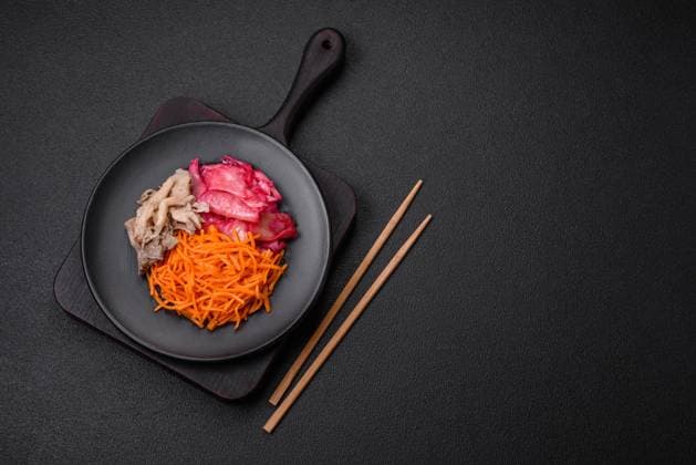 Delicious spicy mushrooms, carrots, cabbage sliced and cooked in Korean style Delicious spicy mushrooms, carrots, cabbage sliced and cooked in Korean style on a ceramic plate on a dark concrete background Copyright: xZoonar.com TetianaxChernykovax 21647946