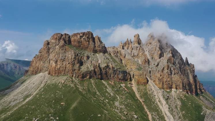 Creative Highlights World Mother-in-law teeth Caucasus mountain Aerial view on Naujiza or Mother-in-law teeth mountain with fantastic cliffs in Kabardino-Balkaria, Caucasus, Russia Copyright: xZoonar.com MikhailxKokhanchikovx 21657593