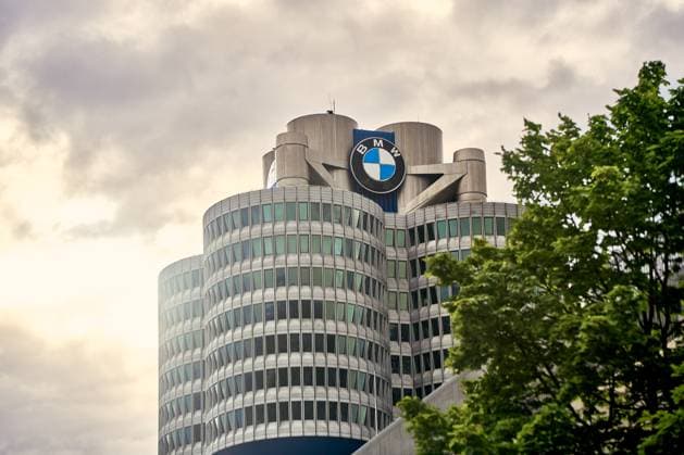 Munich, Bavaria, Germany - June 14, 2024: The BMW headquarters in Munich, Germany, under a cloudy sky. The modern high-rise building with its striking design and the BMW logo is a landmark of the city *** Die BMW Zentrale in München, Deutschland, bei bewölktem Himmel. Das moderne Hochhaus mit seinem markanten Design und dem BMW-Logo ist ein Wahrzeichen der Stadt