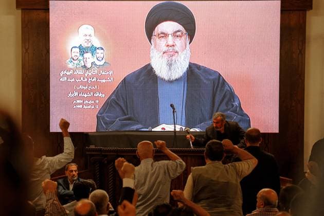 June 19, 2024, Beirut, Beirut, Lebanon: Supporters of pro-Iranian Hezbollah raise their fists as the party Secretary General Hassan Nasrallah appears to give a televised speech during a mass rally to mark one week of the assassination of top party commander Taleb Abdallah and four other in an Israeli air raid in south Lebanon. Beirut Lebanon - ZUMAn313 20240619_zip_n313_003 Copyright: xMarwanxNaamanix