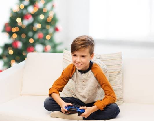 children, technology and people concept - smiling boy with gamepad playing video game at home over christmas tree background. boy with gamepad playing video game at christmas ,model released, Symbolfoto; children, Technik und Personen Konzept lächelnd Junge mit gamepad spielendes Videodermatoskop Spiel im Heimat trueber Weihnachten Baum Hintergrund Junge mit gamepad spielendes Videodermatoskop Spiel im Weihnachten ,model released, Symbolfoto ING_33594_236730