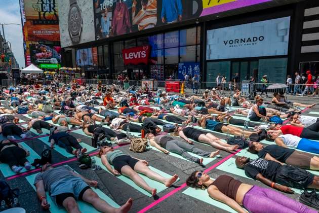 22nd annual Mind over Madness Yoga on the Summer Solstice in Times Square Yoga practitioners pack Times Square in New York in the sweltering heat to practice yoga on the summer solstice, first day of summer, Thursday, June 20, 2024. The 22nd annual Solstice in Times Square, Mind Over Madness stretches the yogis ability to block out the noise and the visual clutter that surround them in the Crossroads of the World. The first day of summer has been declared the International Day of Yoga by the United Nations. (  RichardxB.xLevine