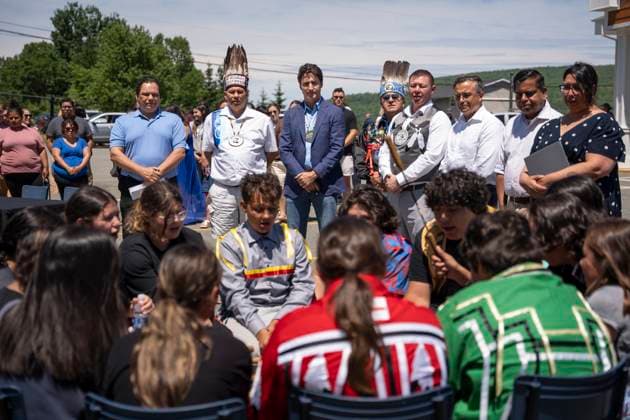 June 21, 2024, WeöÄÃ KoqmaöÄÃ Q First Nat, Ns, Canada: Prime Minister Justin Trudeau, back centre, stands with other dignitaries as students from the We koqma q Mikmaw School drum group White Bear perform during an event marking National Indigenous Peoples Day in We koqmaöÄÃ q First Nation, N.S. on Friday, June 21, 2024. WeöÄÃ KoqmaöÄÃ Q First Nat Canada  - ZUMAc35_ 20240621_zaf_c35_026 Copyright: xDarrenxCalabresex