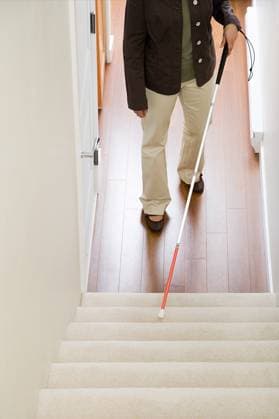 Blind woman using a walking stick on stairway ,model released, Symbolfoto; Blinde Frau anhand einer Spazierengehen kleben am Treppenaufgangs ,model released, Symbolfoto ING_39829_09992 RECORD DATE NOT STATED