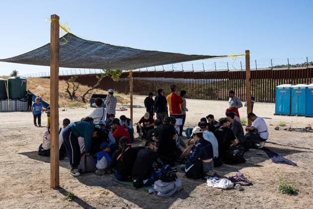 JACUMBA HOT SPRINGS, CA - JUNE 24: Migrants shelter from the sun under parasols after crossing into U.S. from Mexico through an abandoned railroad on June 24, 2024 in Jacumba Hot Springs, San Diego, California.  Copyright: xVCGx 111503898906
