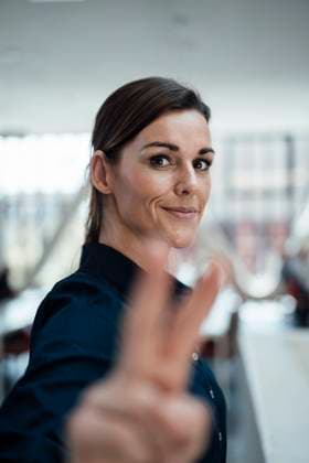 Creative Highlights Symbolbilder Happy businesswoman gesturing at airport lobby model released, Symbolfoto property released, JOSEF24568