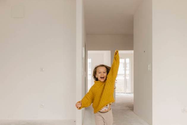 Creative Highlights Symbolbilder Excited girl with arm raised enjoying in new apartment model released, Symbolfoto property released, VIVF01324
