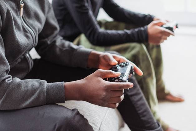 Two boys (10-11), (14-15) playing video game at home model released Copyright: xIko-OjoxMercyxHarunax