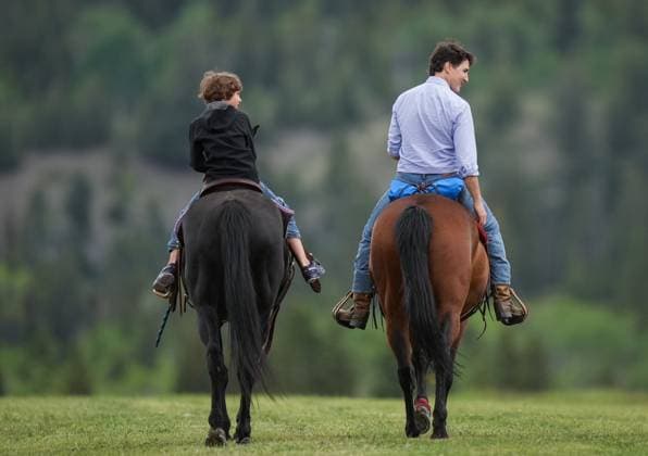 June 26, 2024, Nemaiah Valley, Bc, CANADA: Prime Minister Justin Trudeau and his son Hadrien, 10, ride horses while attending community celebrations to mark the 10th anniversary of the Tsilhqot in decision, in Nemaiah Valley, B.C., on Wednesday, June 26, 2024. In 2014, the Supreme Court of Canada granted Tsilhqot in aboriginal title to more than 1,750 square kilometres of land in the Nemaiah Valley. Nemaiah Valley CANADA - ZUMAc35_ 20240626_zaf_c35_120 Copyright: xDarrylxDyckx