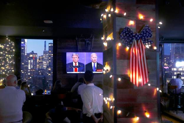 Visitors to a rooftop bar in Times Square watch the CNN presidential debate between President Joe Biden and former President Donald Trump in New York on Thursday, June 27, 2024. The debate is being held in CNN s Atlanta studios with Jake Tapper and Dana Bash as moderators.  NYP20240627310 JOHNxANGELILLO