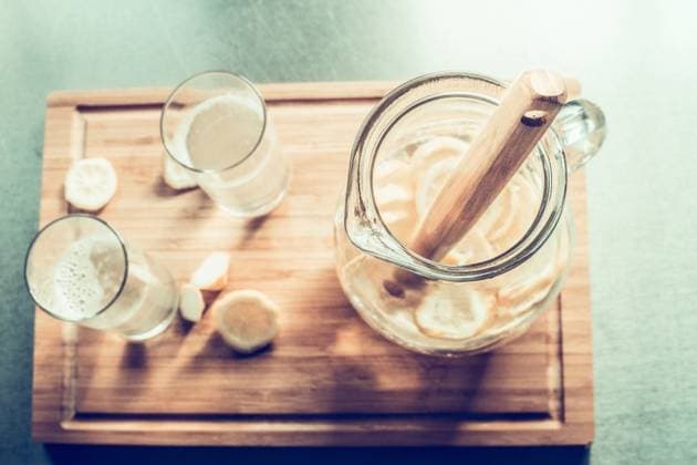Jug of lemonade on cutting board , top view, toned. Summer drinks with lemon ,model released, Symbolfoto