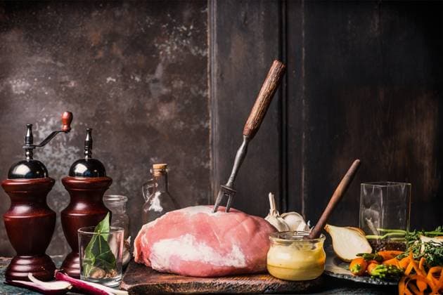Pork Ham meat with Honey Mustard Glaze and ingredients, preparation on aged kitchen table at dark rustic wooden background, side view, place for text ,model released, Symbolfoto