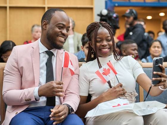July 1, 2024, Winnipeg, Mb, Canada: New Canadian citizens Henry and Oreo Amogu, originally from Nigeria, take a selfie during a Canada Day citizenship ceremony at the Assiniboine Park Pavilion in Winnipeg, Man., Monday July 1, 2024. Winnipeg Canada  - ZUMAc35_ 20240701_zaf_c35_149 Copyright: xDavidxLipnowskix