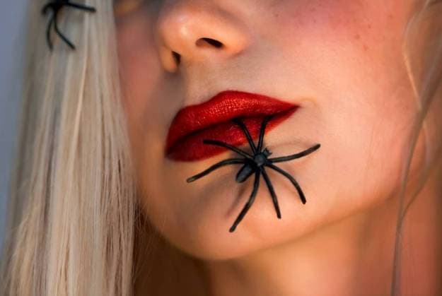 Halloween Makeover Fashion Ideas. Beautiful Female Face with Spiders. Holiday Makeup. Bright Red Lipstick. Blond Hair. Girl Model. Lips Closeup.. Halloween Fashion Portrait ,model released, Symbolfoto