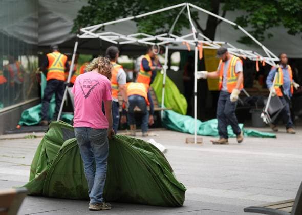 July 5, 2024, Montreal, Pq, CANADA: A pro-Palestinian protester drags his personal belongings as city worker dismantle tents inside an encampment in Victoria Square in Montreal, Friday, July 5, 2024. Montreal CANADA  - ZUMAc35_ 20240705_zaf_c35_019 Copyright: xChristinnexMuschix